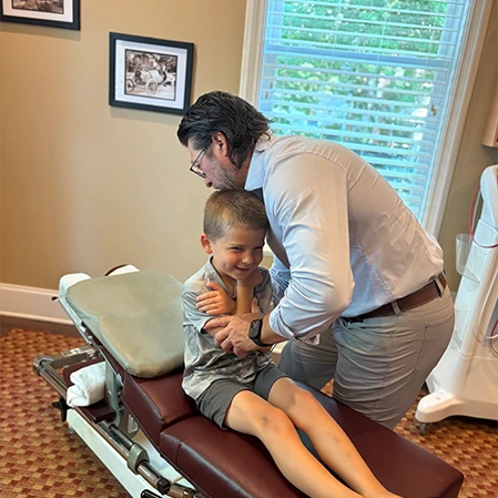 Chiropractor Thomas McKay Jr. Adjusting Pediatic Patient