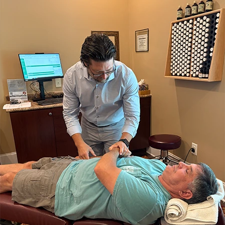 Chiropractor Thomas McKay Jr. With Back Pain Patient